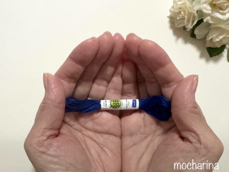 手のひらに刺し子糸を乗せている写真。小さな刺し子糸を両手で包み込むように持っている写真。